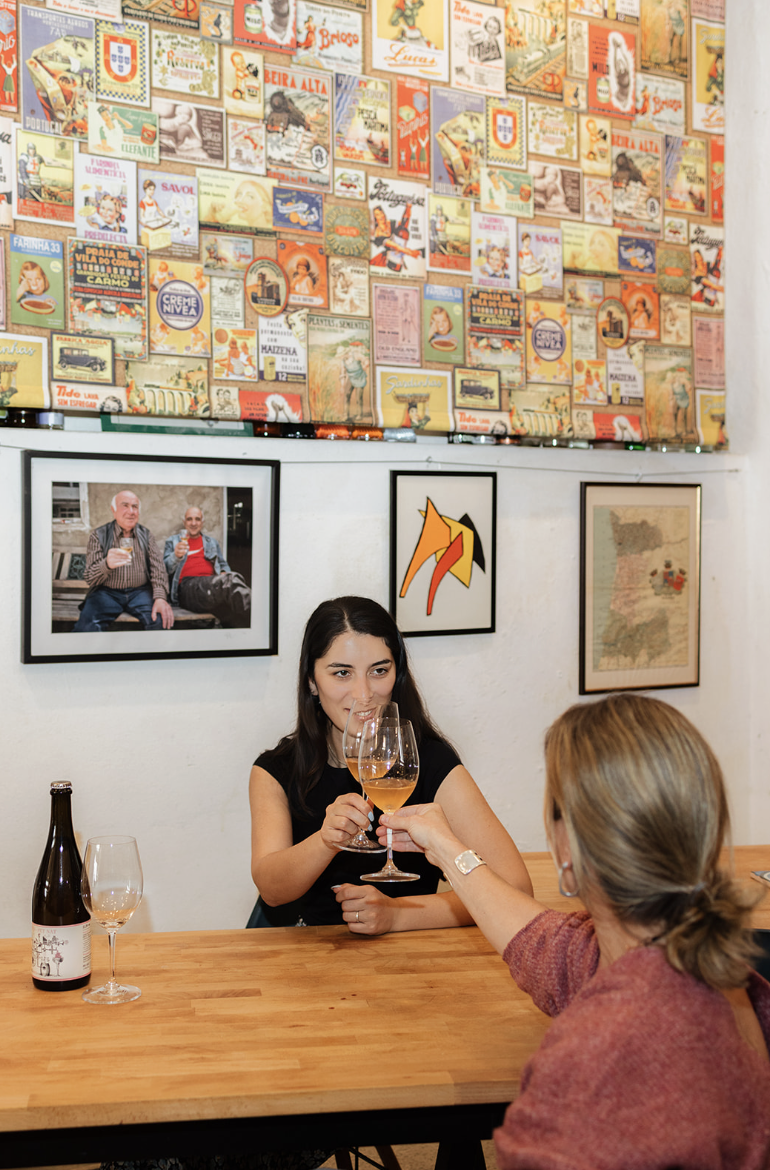 Two women clinking glasses